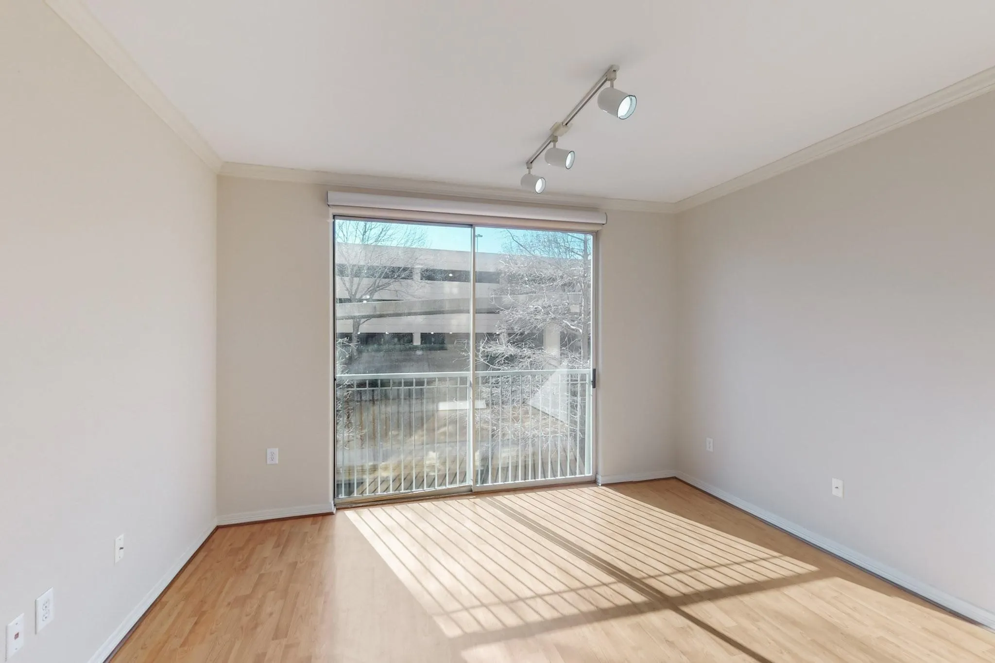 Unfurnished room with track lighting, light wood finished floors, and ornamental molding