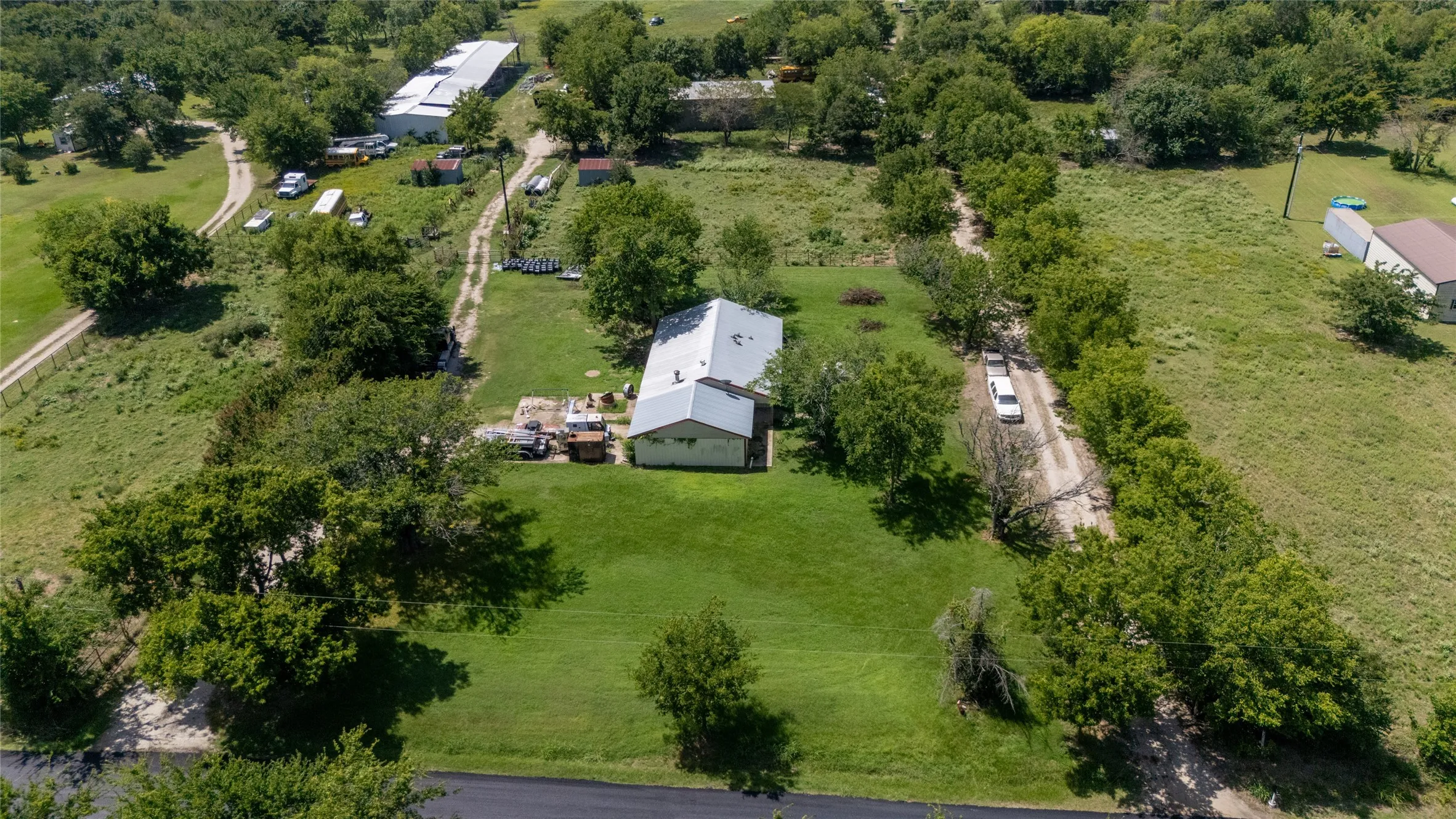 Expansive lot featuring a single-story structure with a light-colored roof
