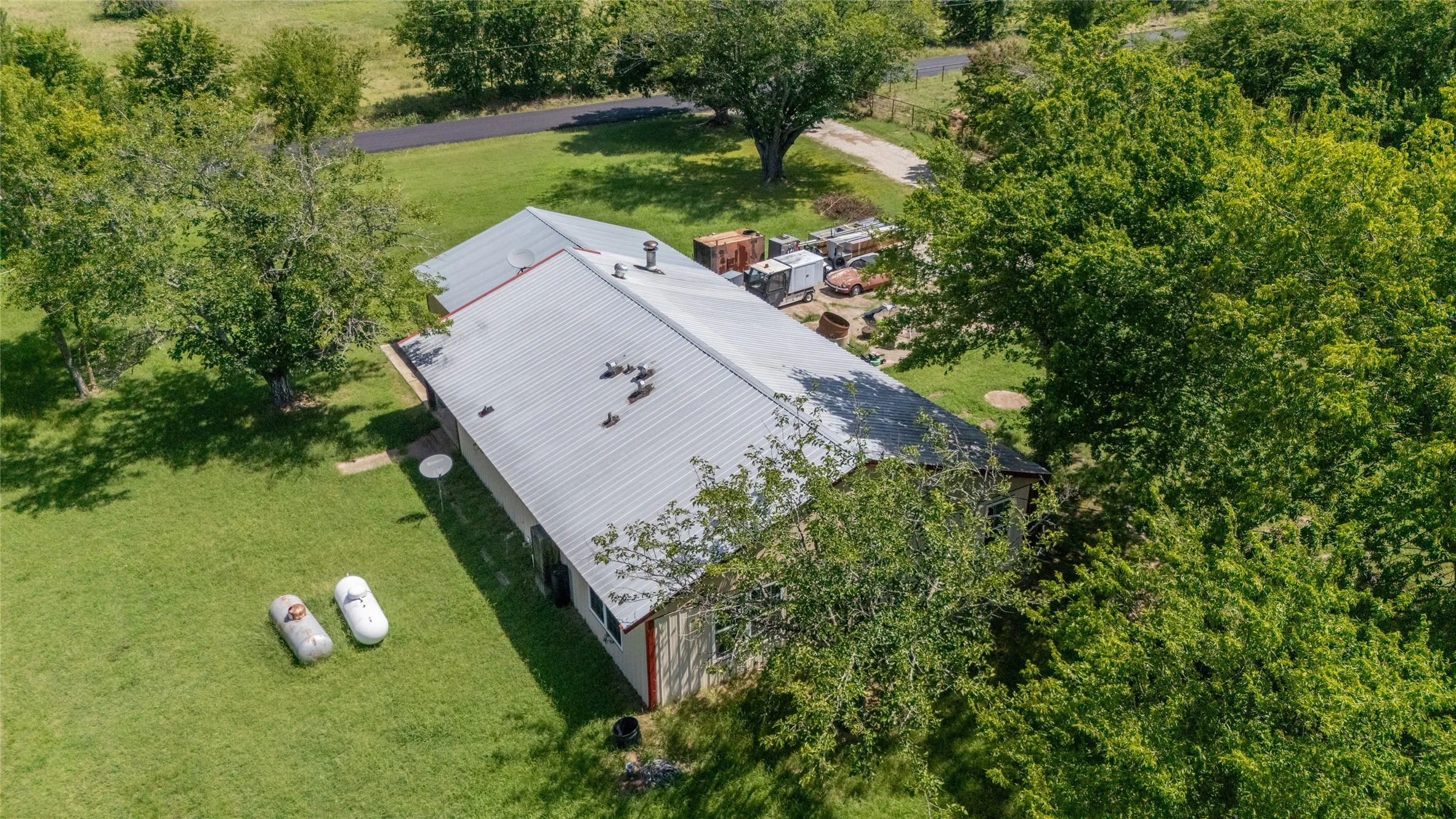 Expansive property featuring a single-story structure with a metal roof