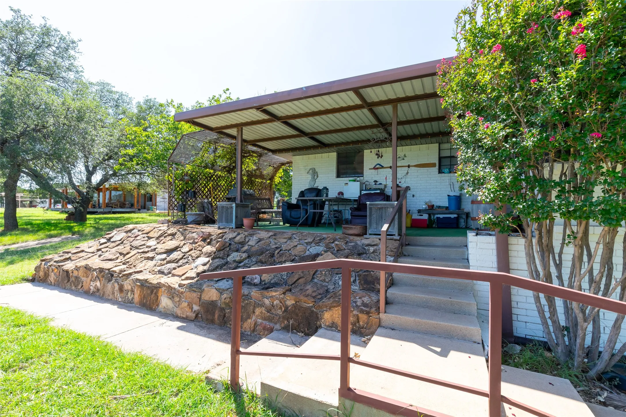 Covered patio with a metal roof and concrete steps