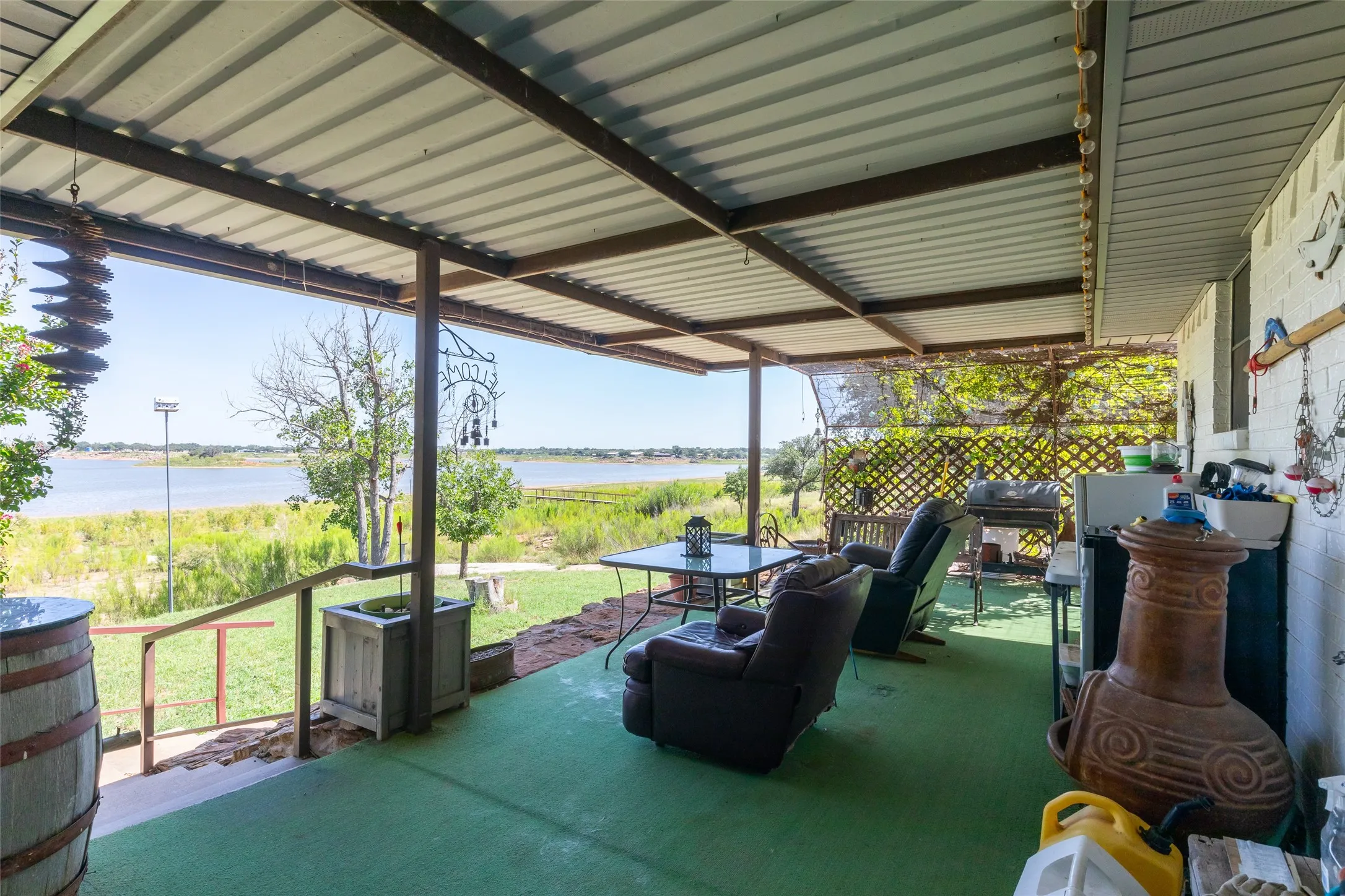Covered outdoor patio with a corrugated metal roof and exposed support beams