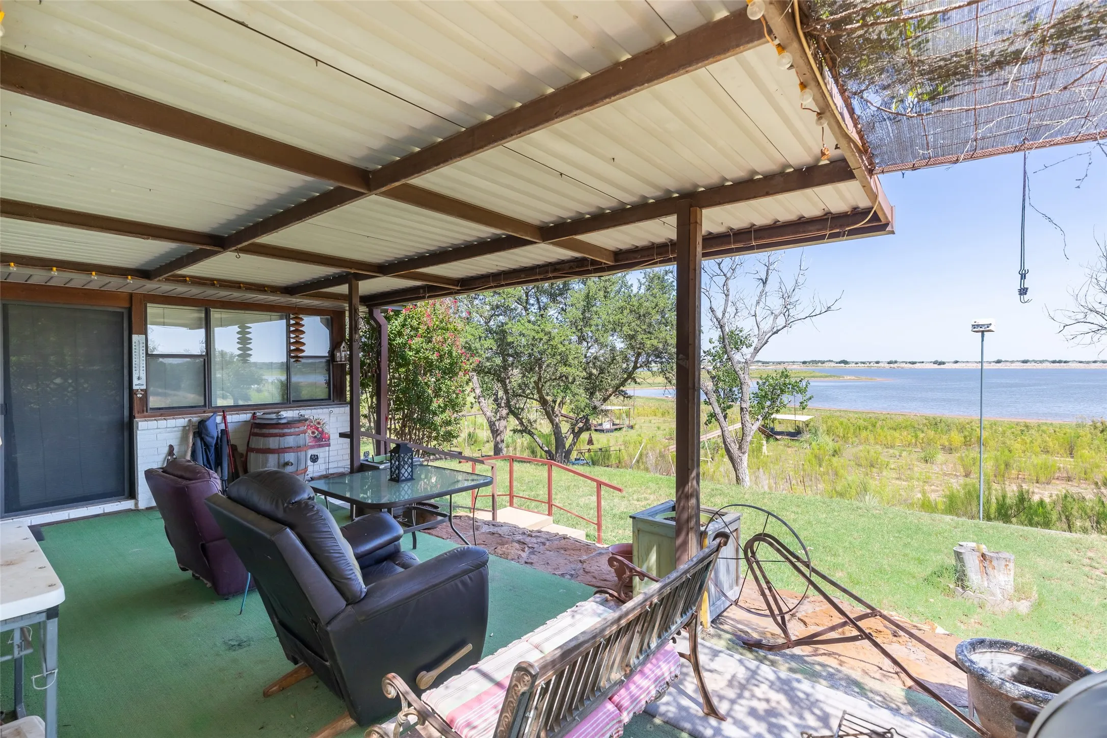 Covered patio featuring a corrugated metal roof and exposed metal beams