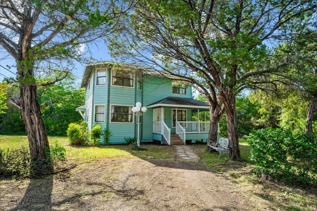 Two-story residential structure with light blue siding and white trim