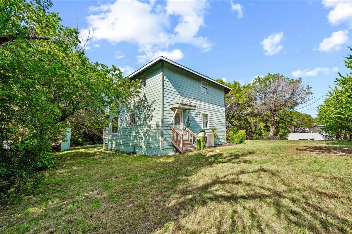Two-story residence with a covered porch and white railing