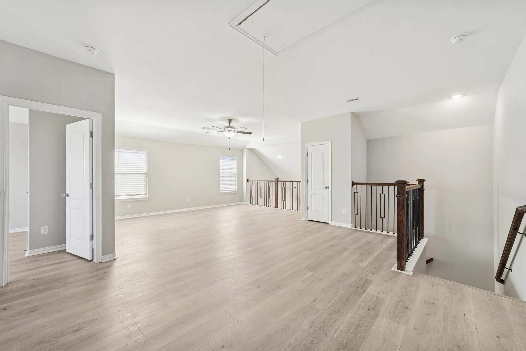 Game room with attic access and vaulted ceiling