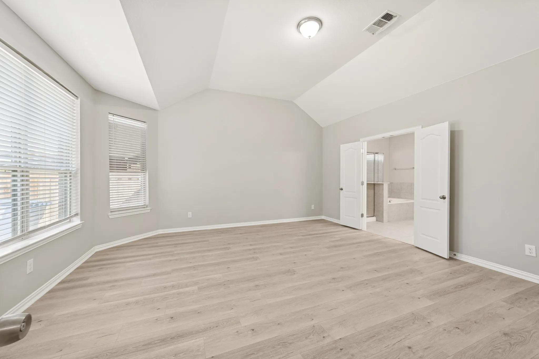 Master bedroom with lofted ceiling, and ensuite bath