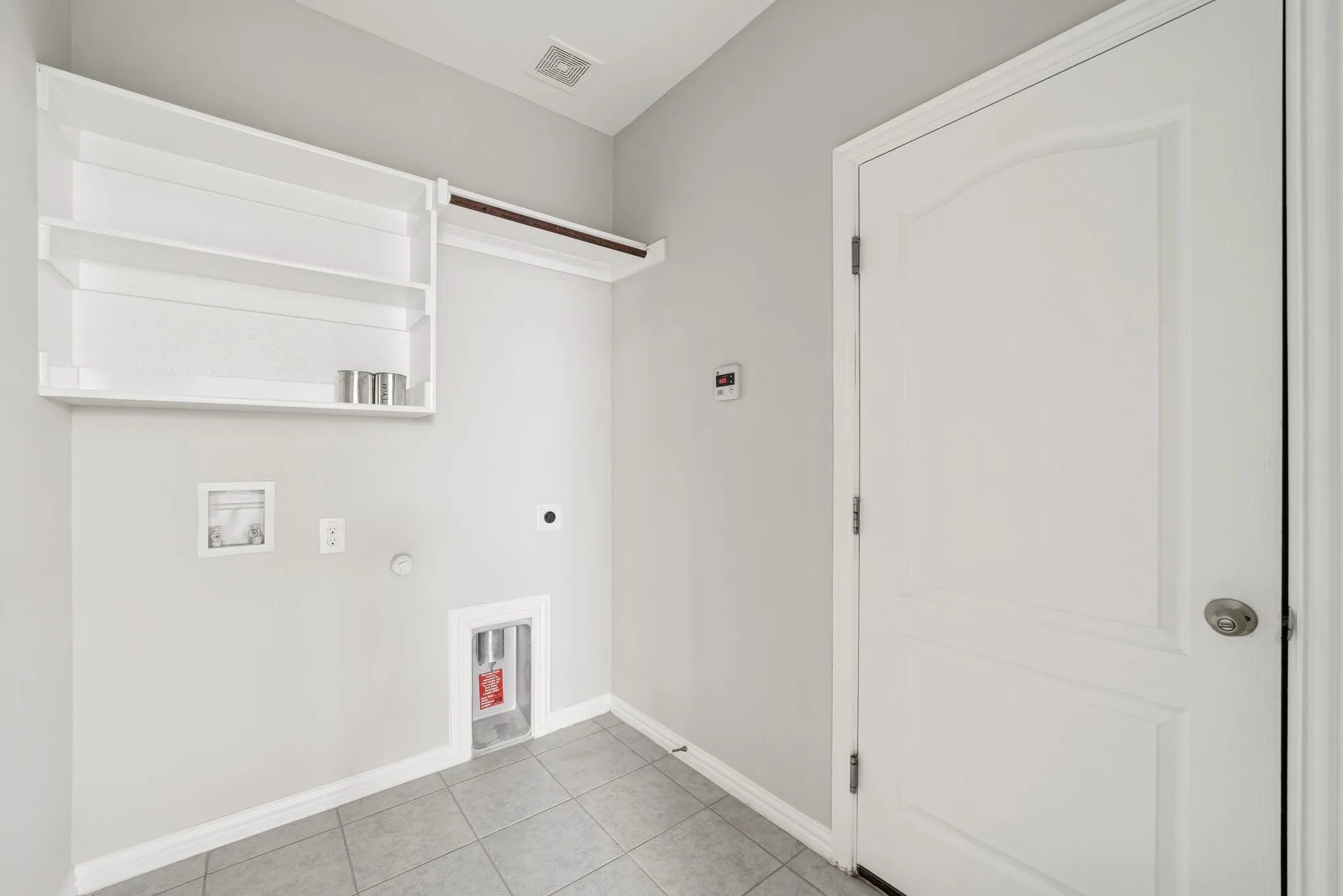 Laundry area featuring gas dryer hookup, light tile patterned floors, washer hookup, and electric dryer hookup