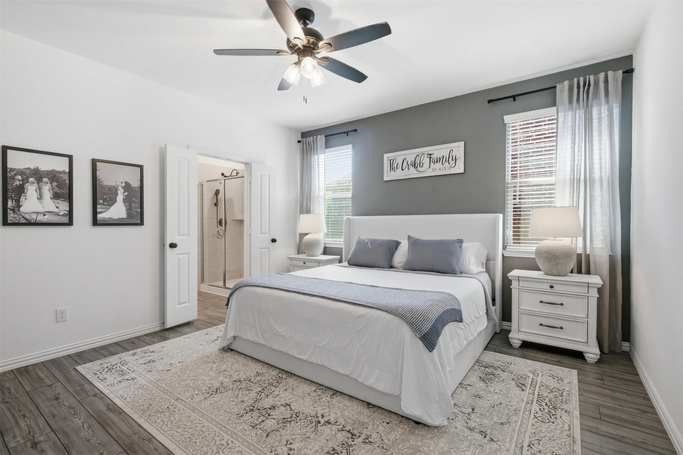 Main bedroom with grey accent wall, modern black ceiling fan