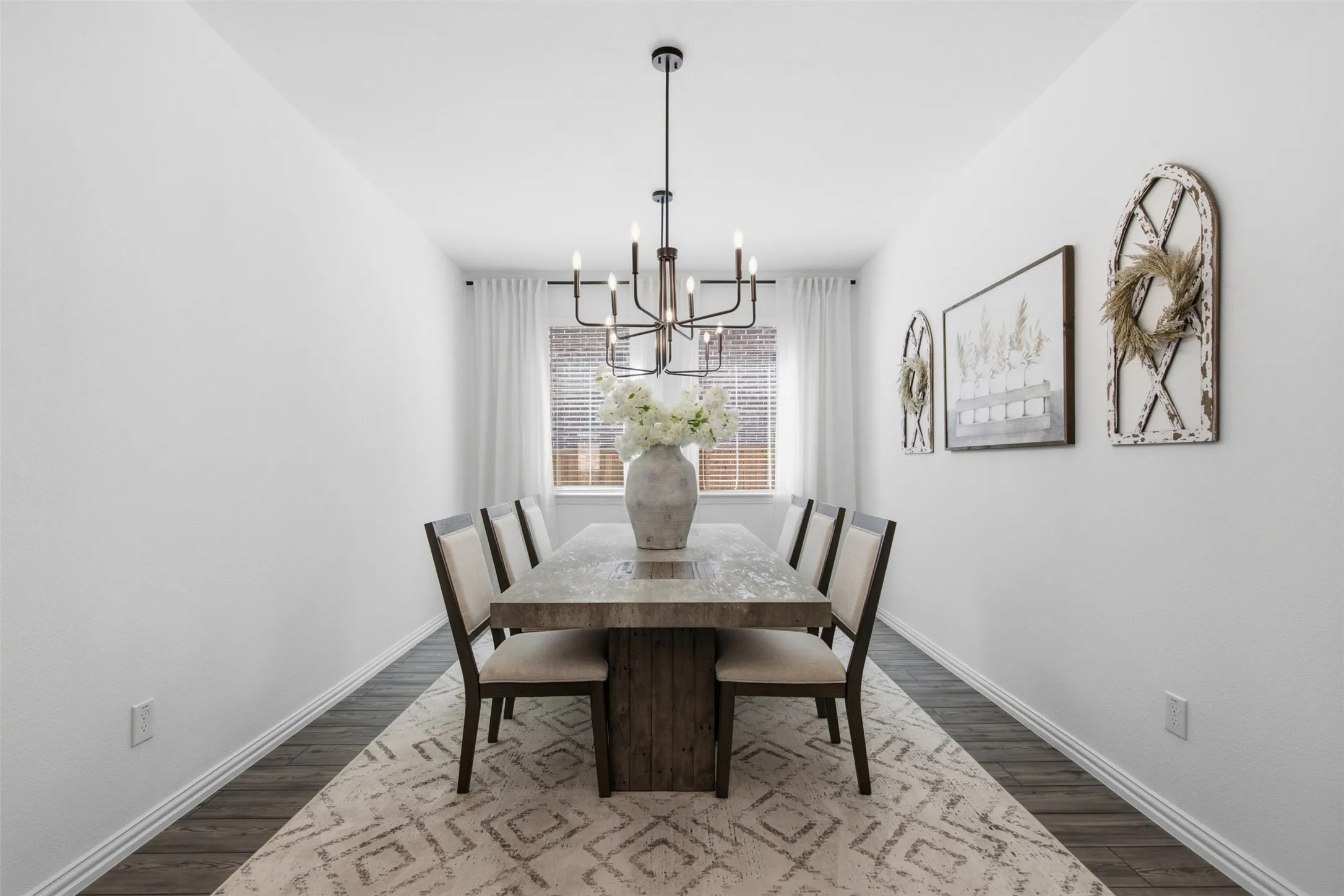 Light filled dining room, easily fits 8, with dual custom selected modern, multi tiered candle style chandeliers