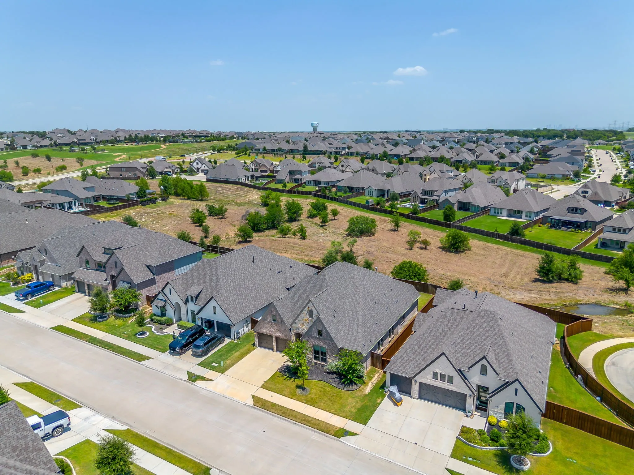 Expansive residential development featuring numerous single-family homes with pitched roofs and manicured front landscaping