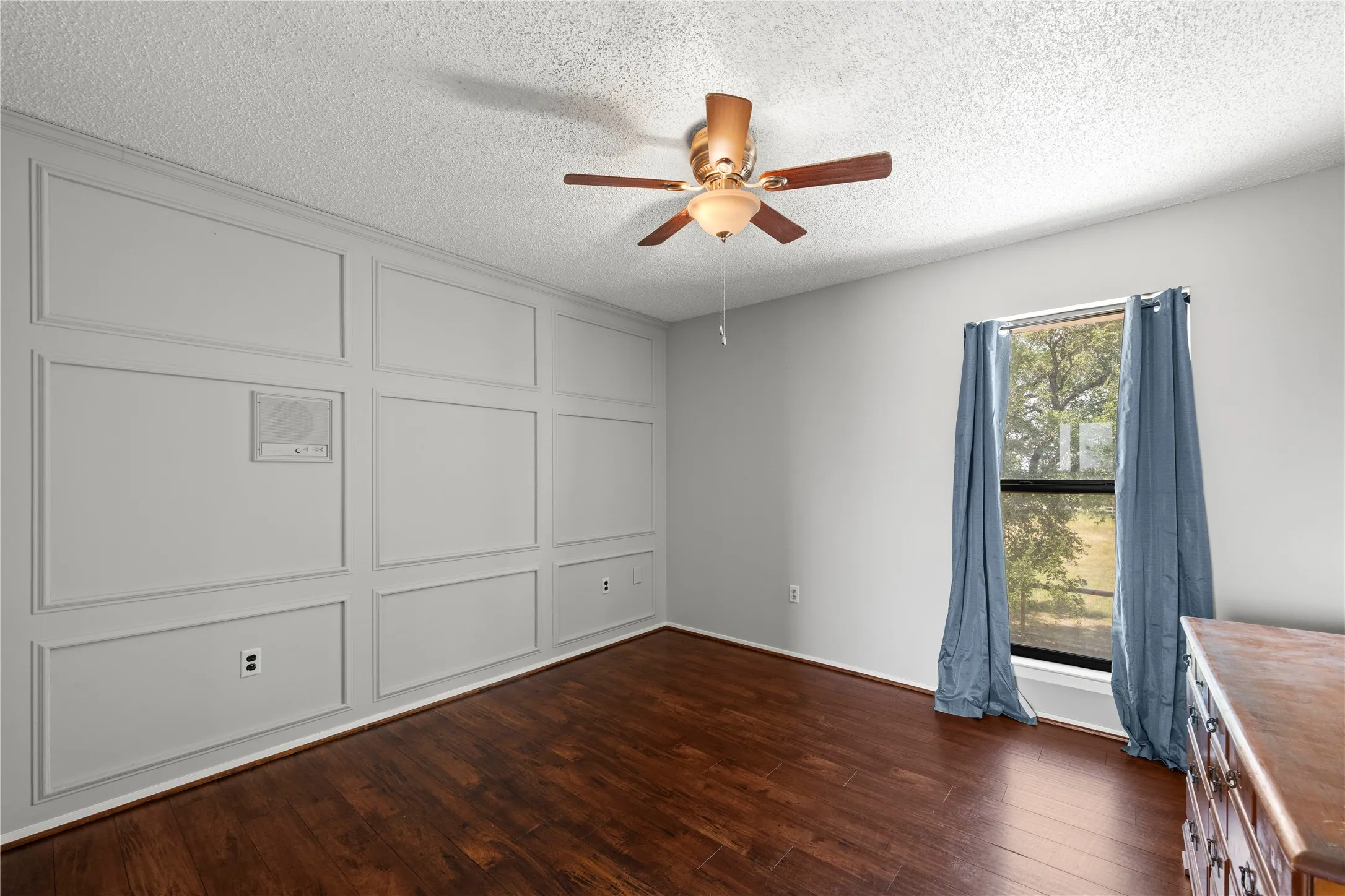 Guest bedroom featuring a paneled accent wall and excellent view