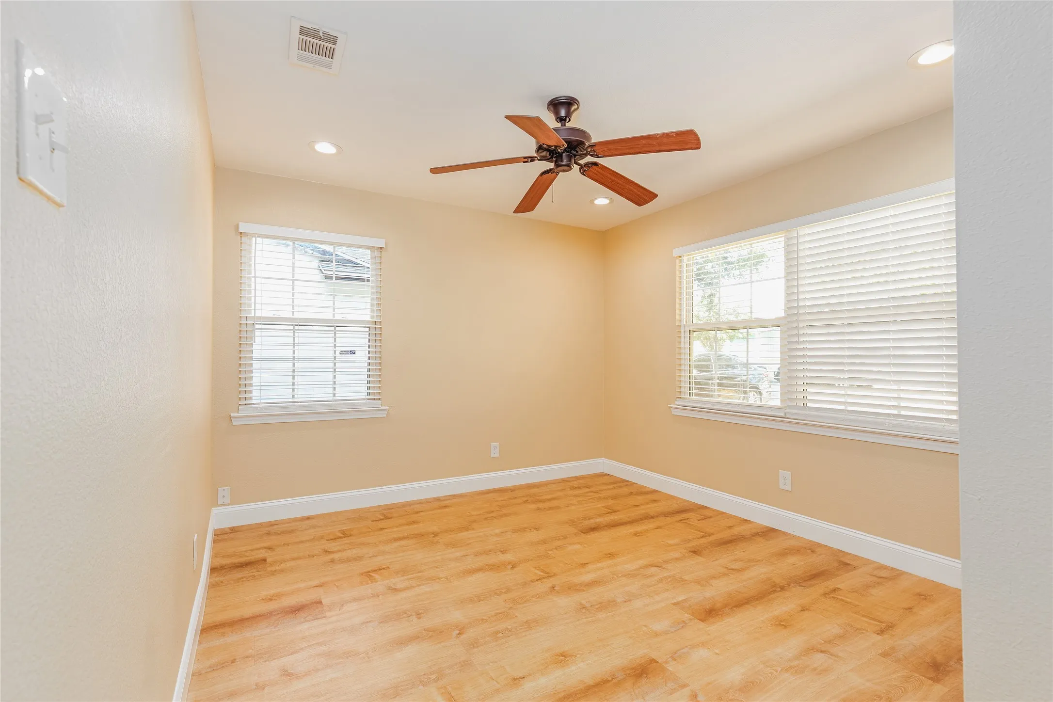 LVP flooring, recessed lighting, ceiling fan, and multiple windows