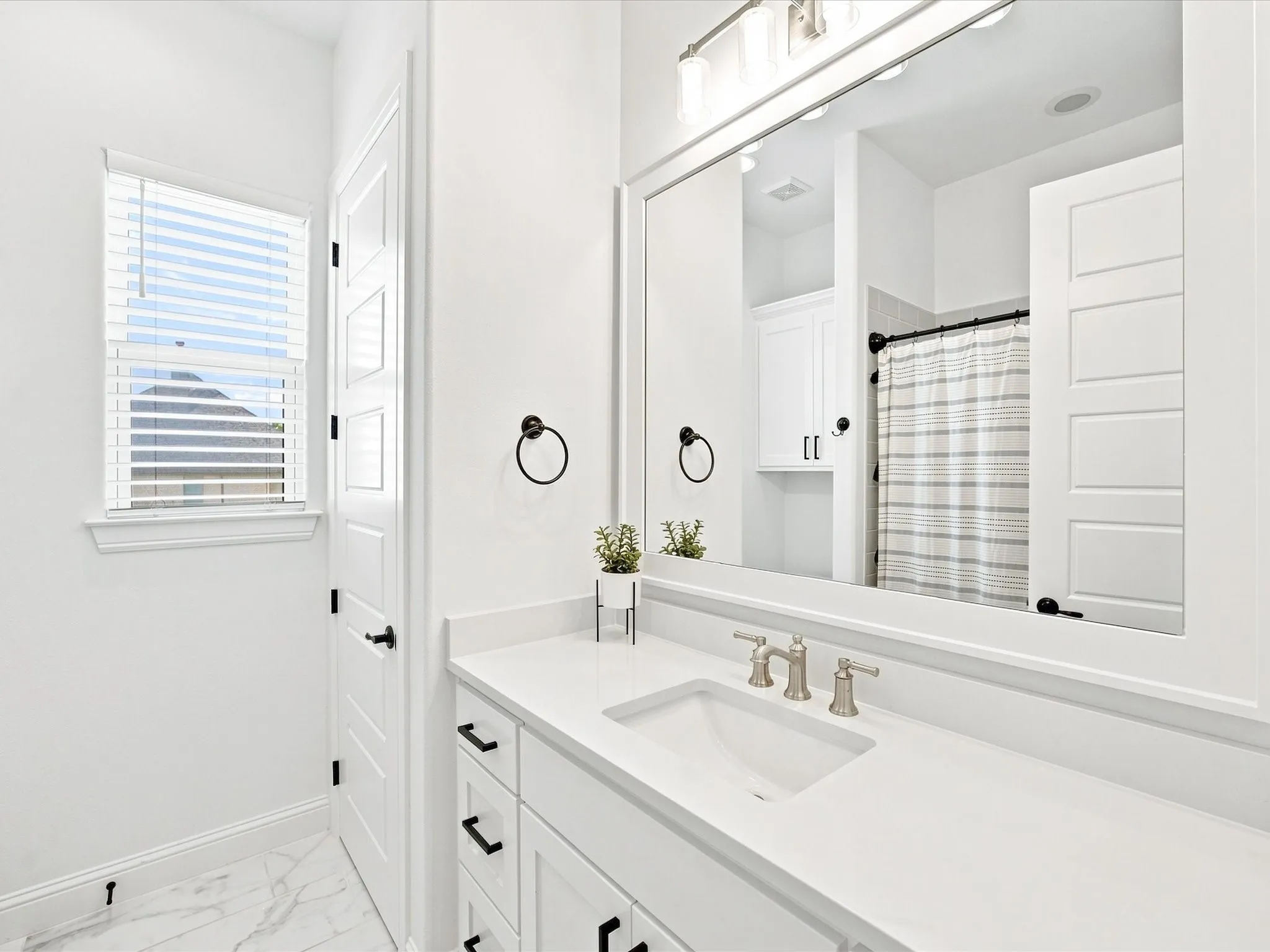 Bathroom featuring a frameless mirror with shower bath combo.