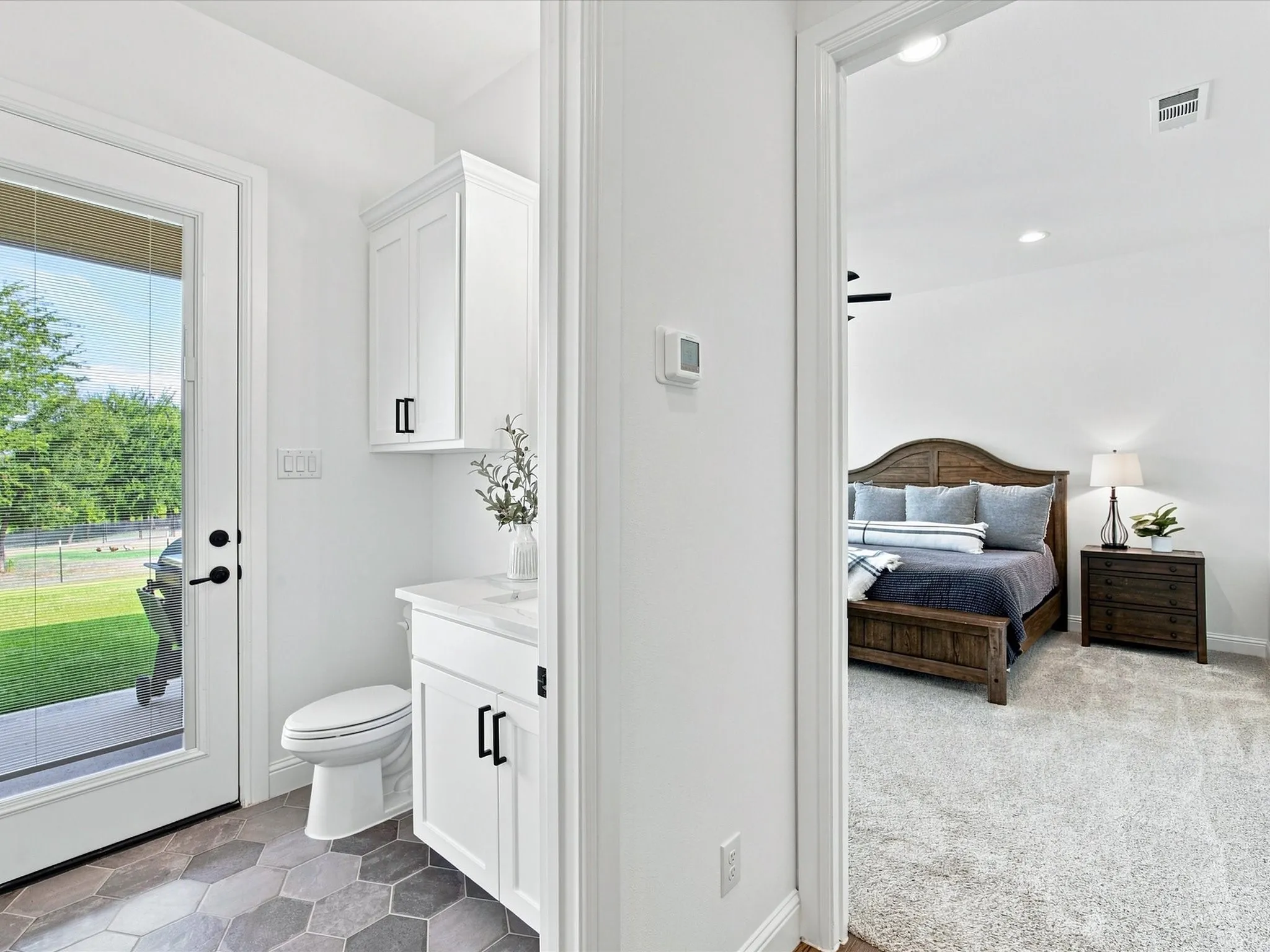 Guest half bathroom with back patio access.