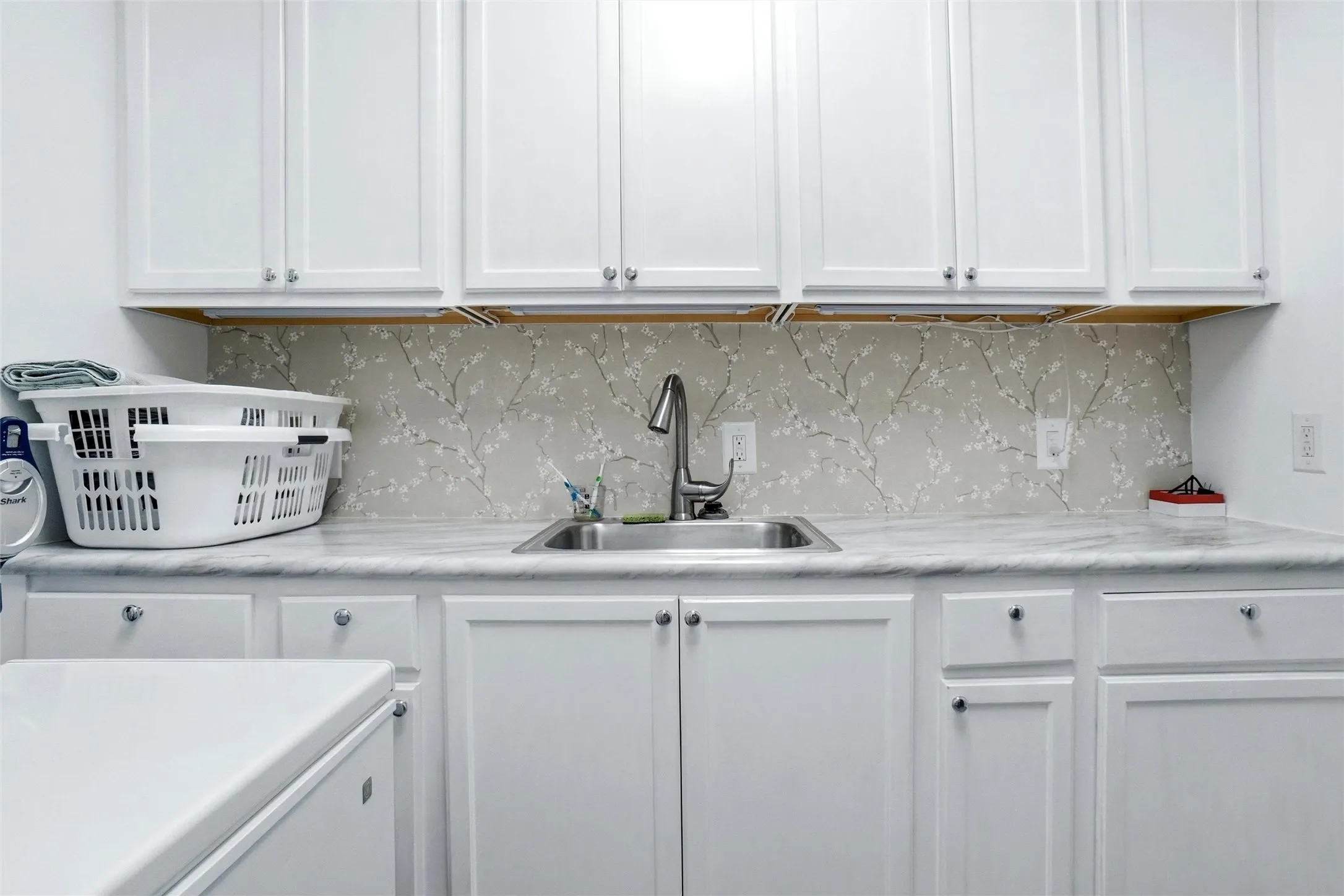 White cabinetry featuring brushed nickel hardware