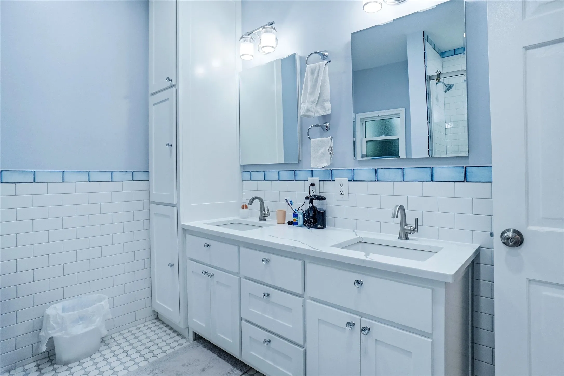 Double vanity with white cabinetry and integrated sinks