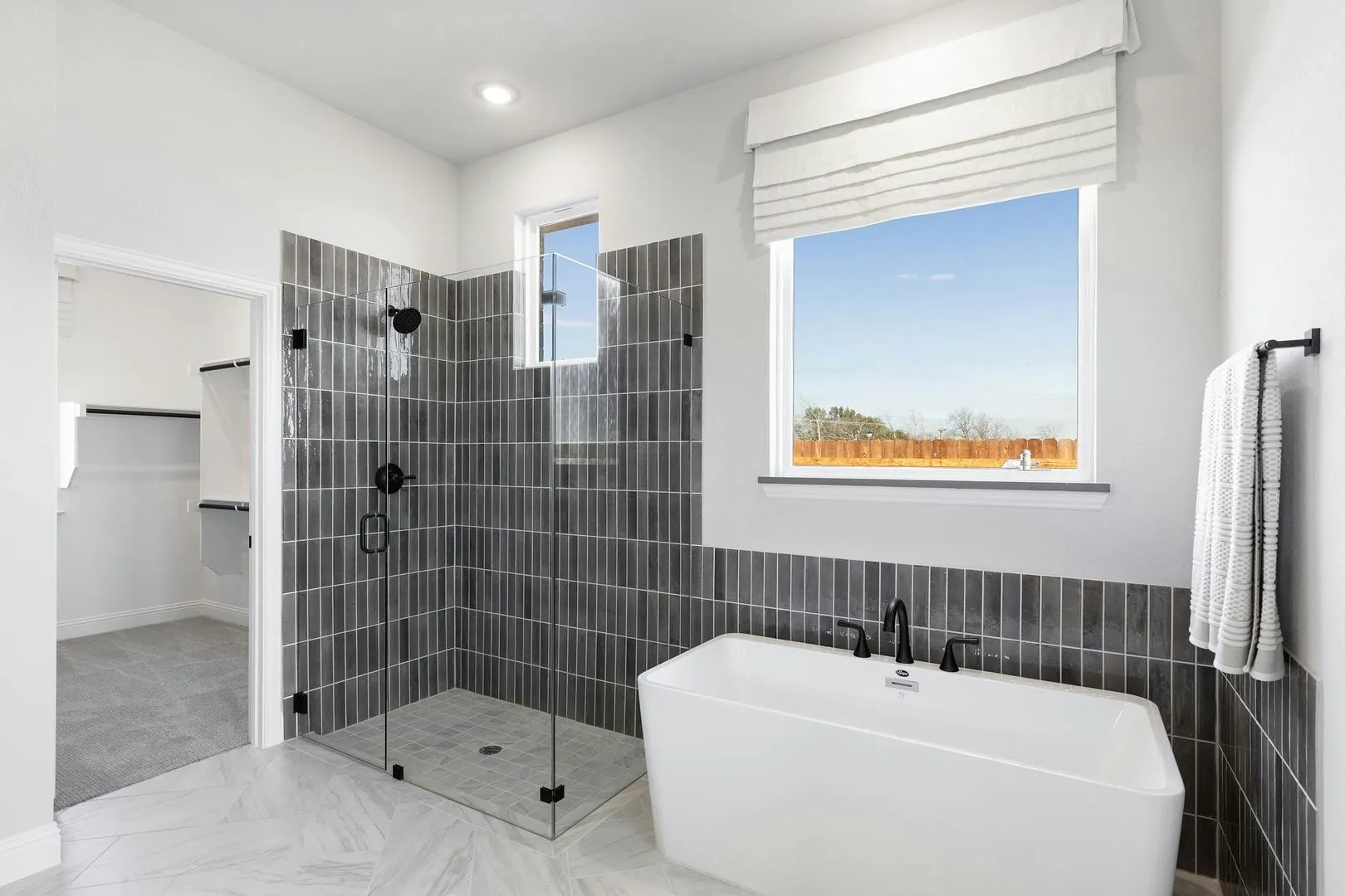 Master bathroom shower and tub of Kentsdale Farms home in DeSoto, TX by Kindred Homes