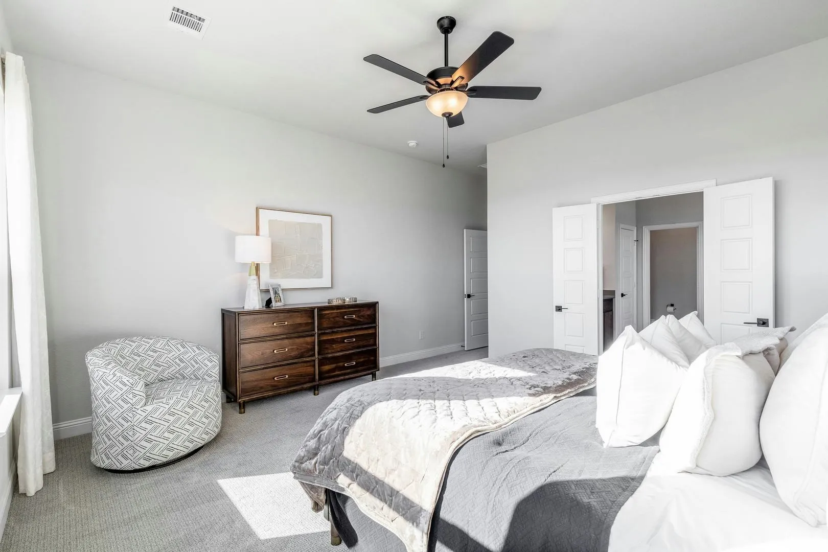 Master bedroom and bathroom of Kentsdale Farms home in DeSoto, TX by Kindred Homes