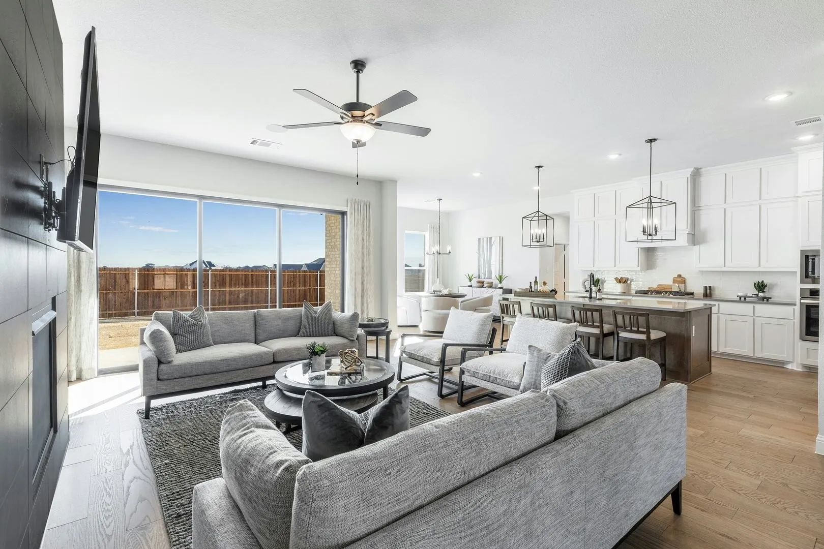 Living room and kitchen of Kentsdale Farms home in DeSoto, TX by Kindred Homes