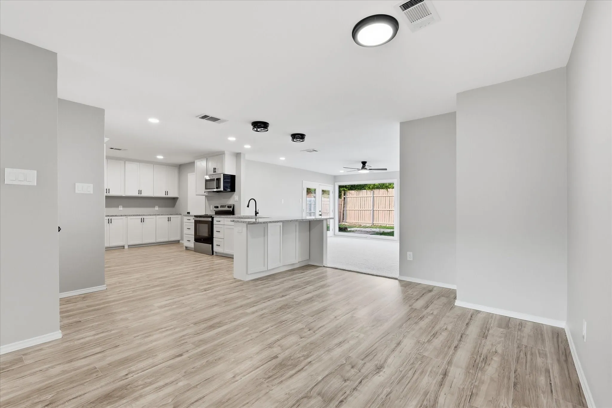 Open concept living space featuring wood-finish flooring