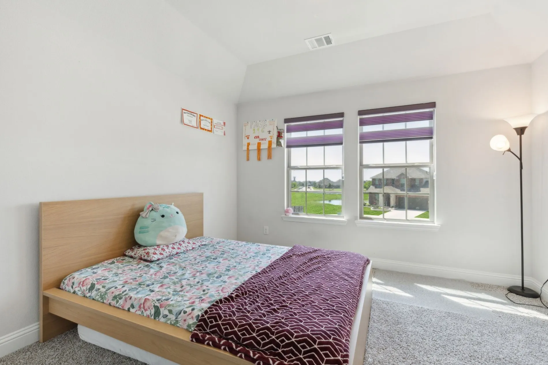 Bright interior space with light gray wall paint and matching gray carpet flooring