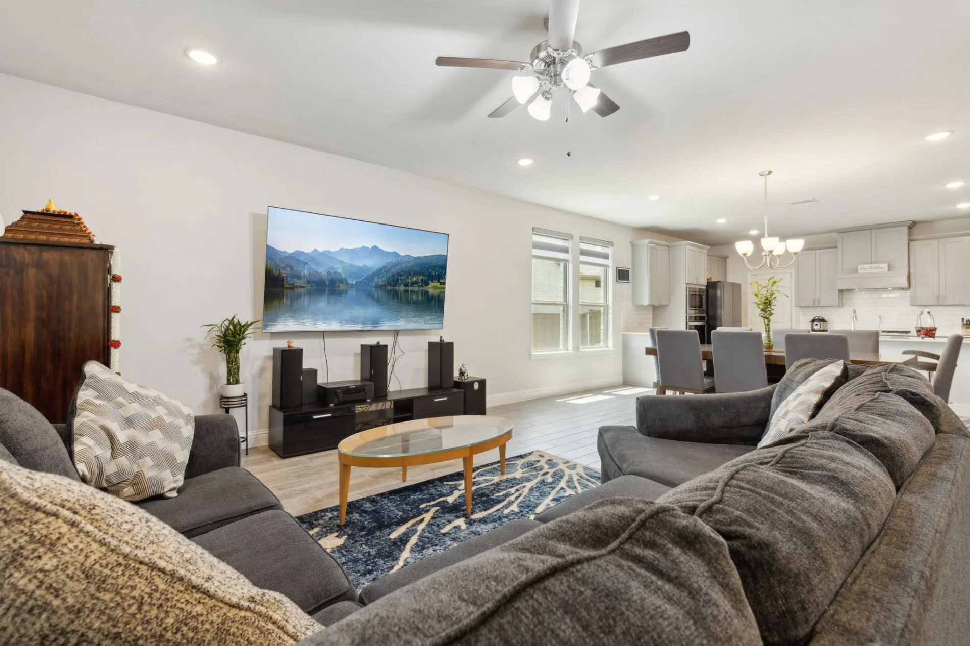 Open-concept living space featuring wood-finish flooring, recessed lighting, and a ceiling fan