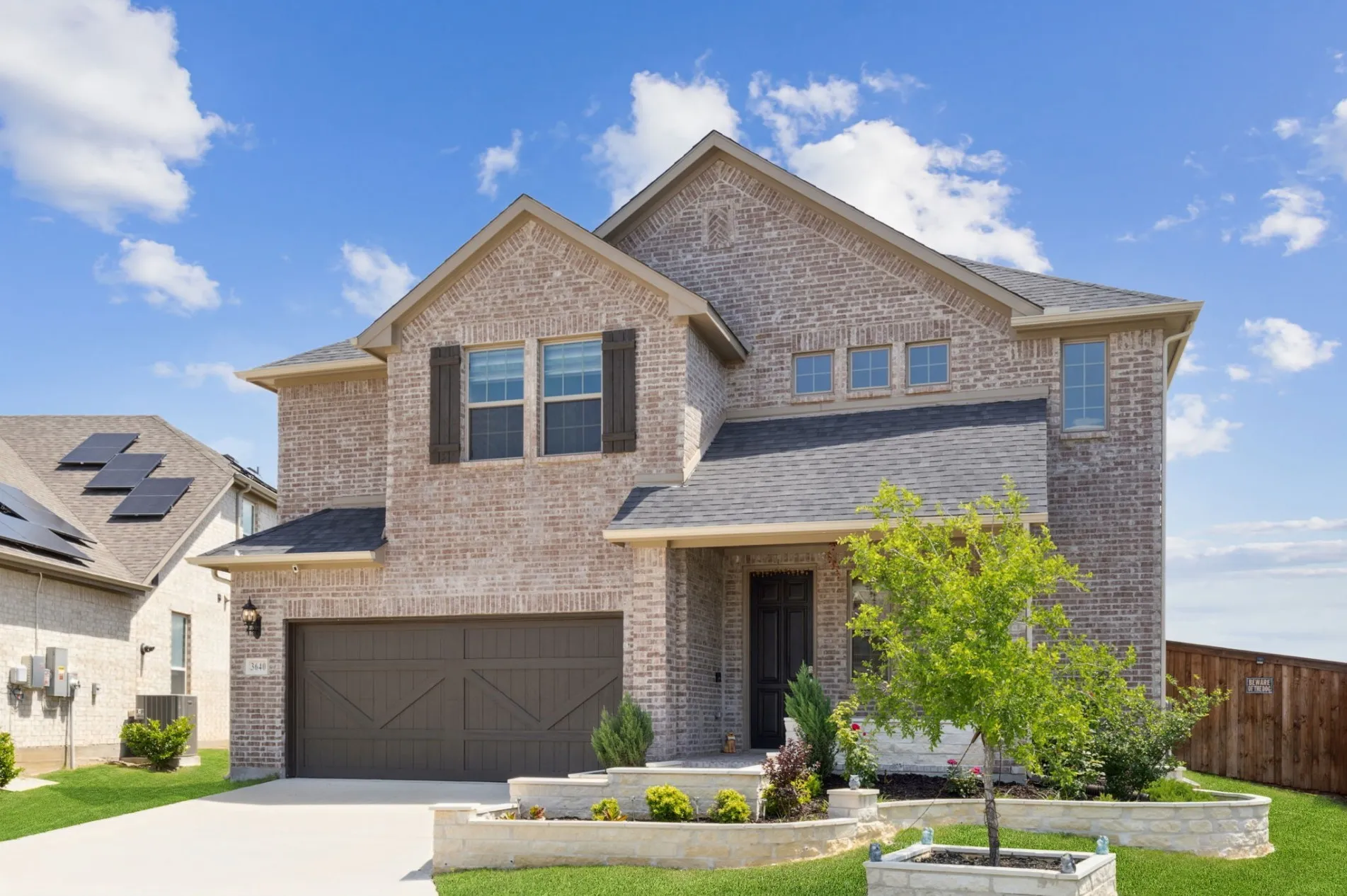 Two-story brick exterior with a two-car garage