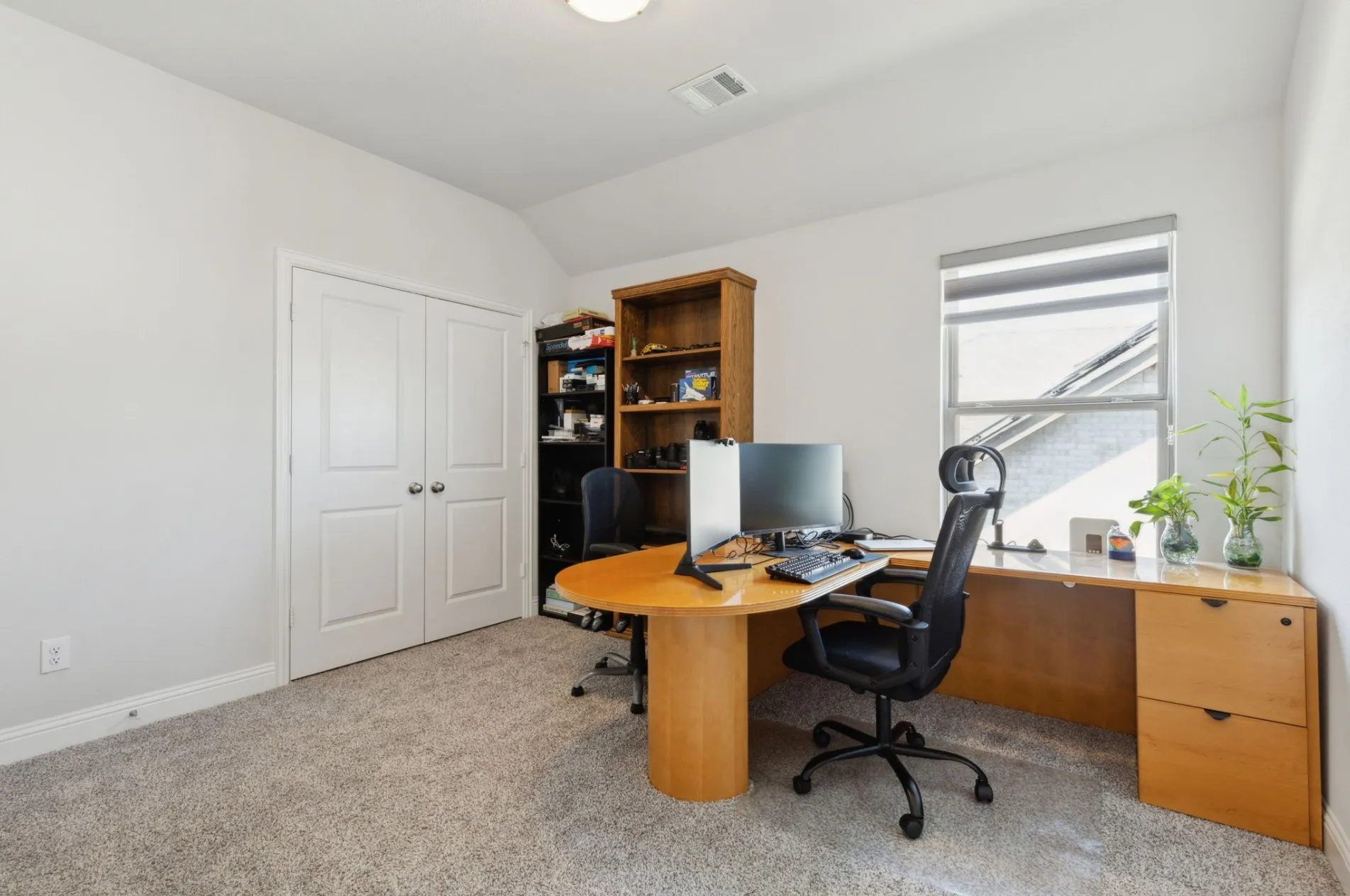 Carpeted room featuring a double-door closet, a single window with blinds, and white painted walls
