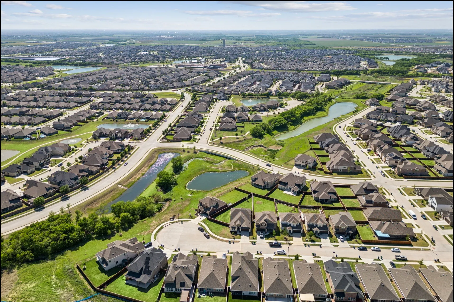 Expansive aerial perspective showcasing a residential development with numerous single-family homes