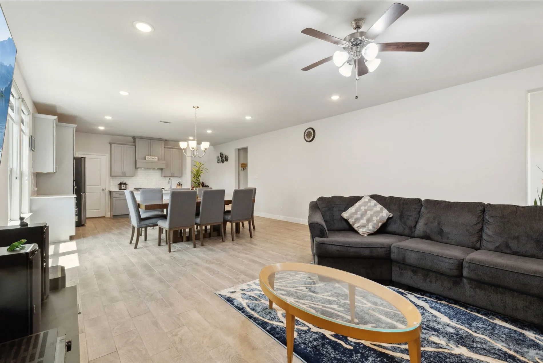 Open-concept living space featuring wood-finish flooring, recessed lighting, and a ceiling fan