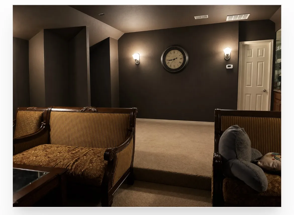 Carpeted lower-level room with dark wall paint and recessed ceiling
