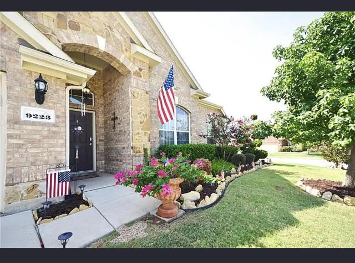 Brick and stone facade featuring an arched entryway