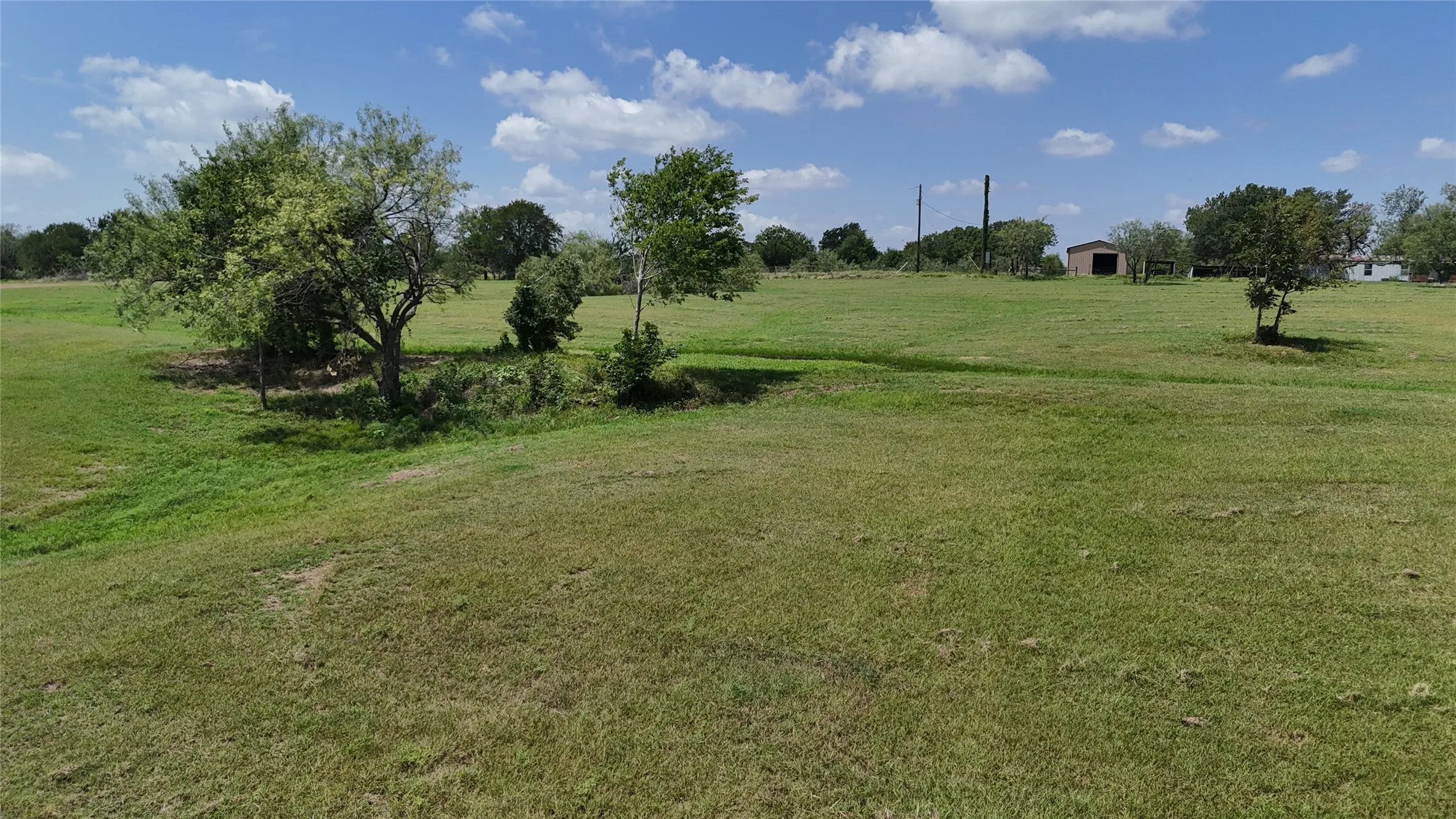Mature shade tree enhances the natural beauty of this level homesite.