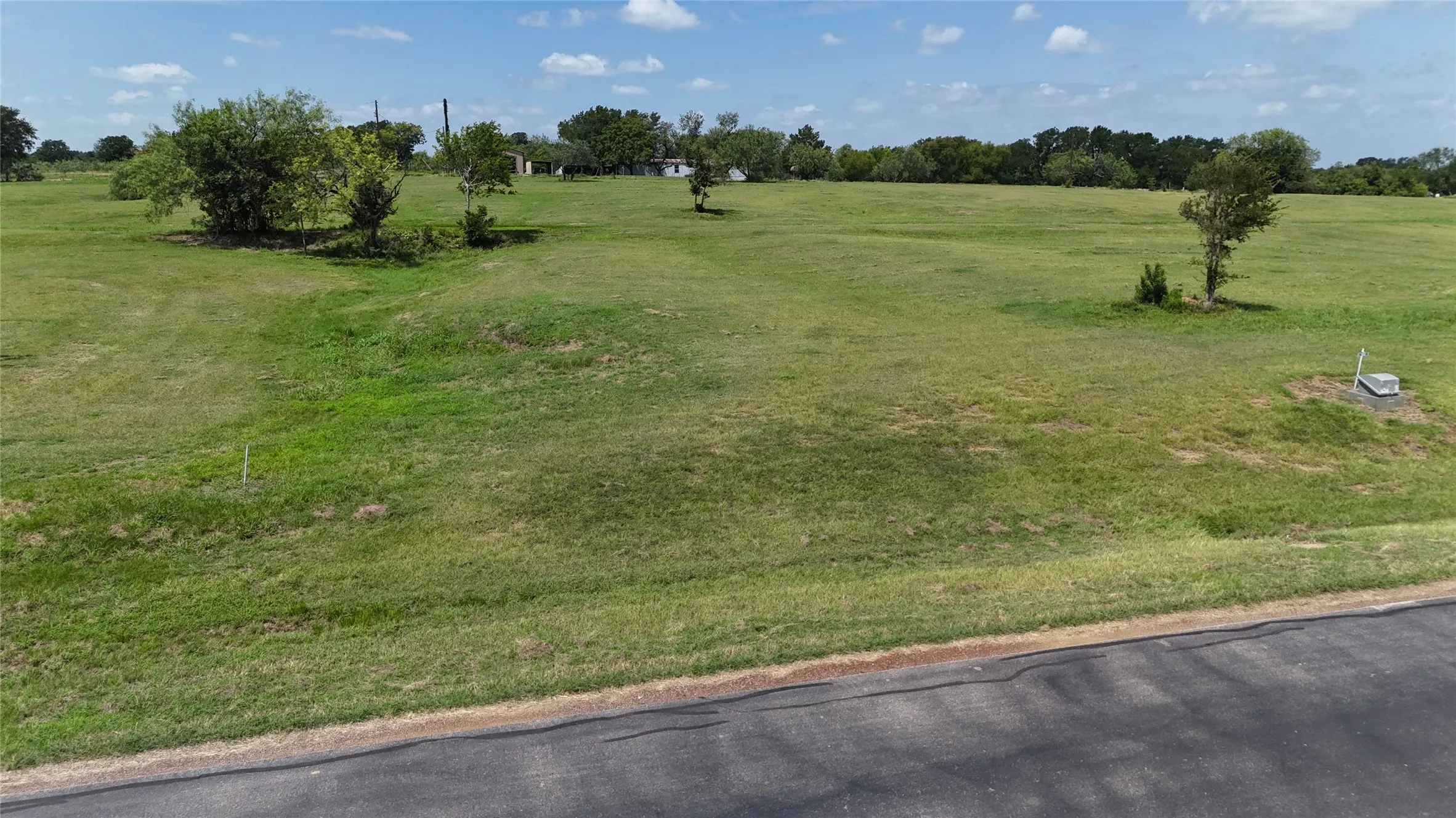Wide view of the open homesite with plenty of space for your dream residence.