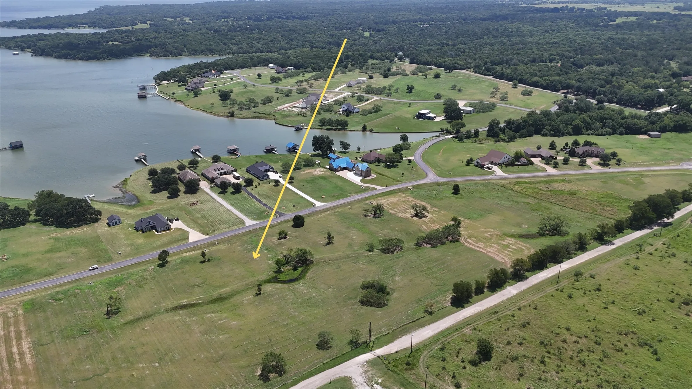 Elevated neighborhood view featuring lake access and surrounding custom homes.
