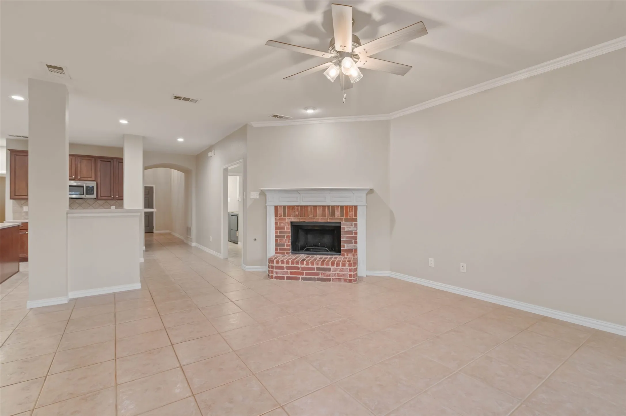 Open floor plan living area off the kitchen and breakfast area with wood burning fireplace.