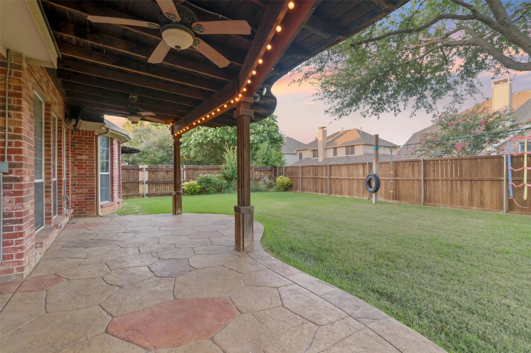 Large yard and covered patio with ceiling fans. Perfect for evenings outside.