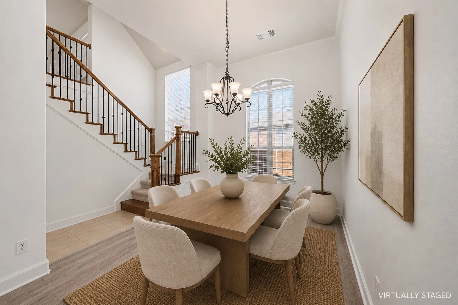 Bright dining area featuring a tiered chandelier, an arched window with blinds, and wood-finish flooring
