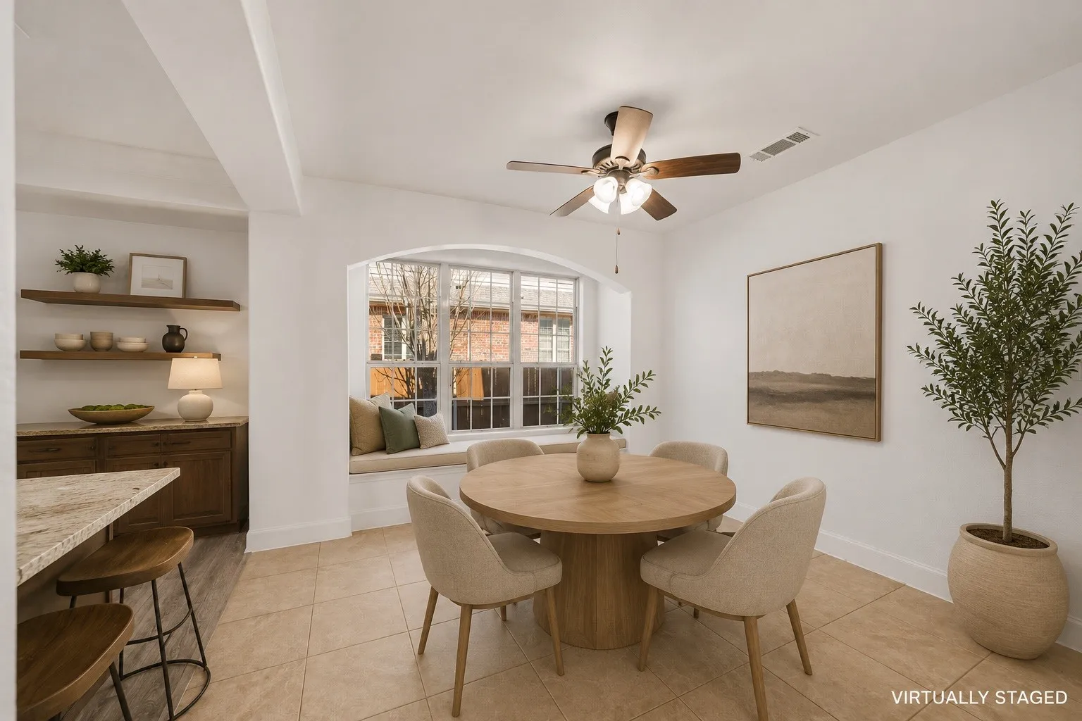 Dining area featuring an arched window with an integrated window seat