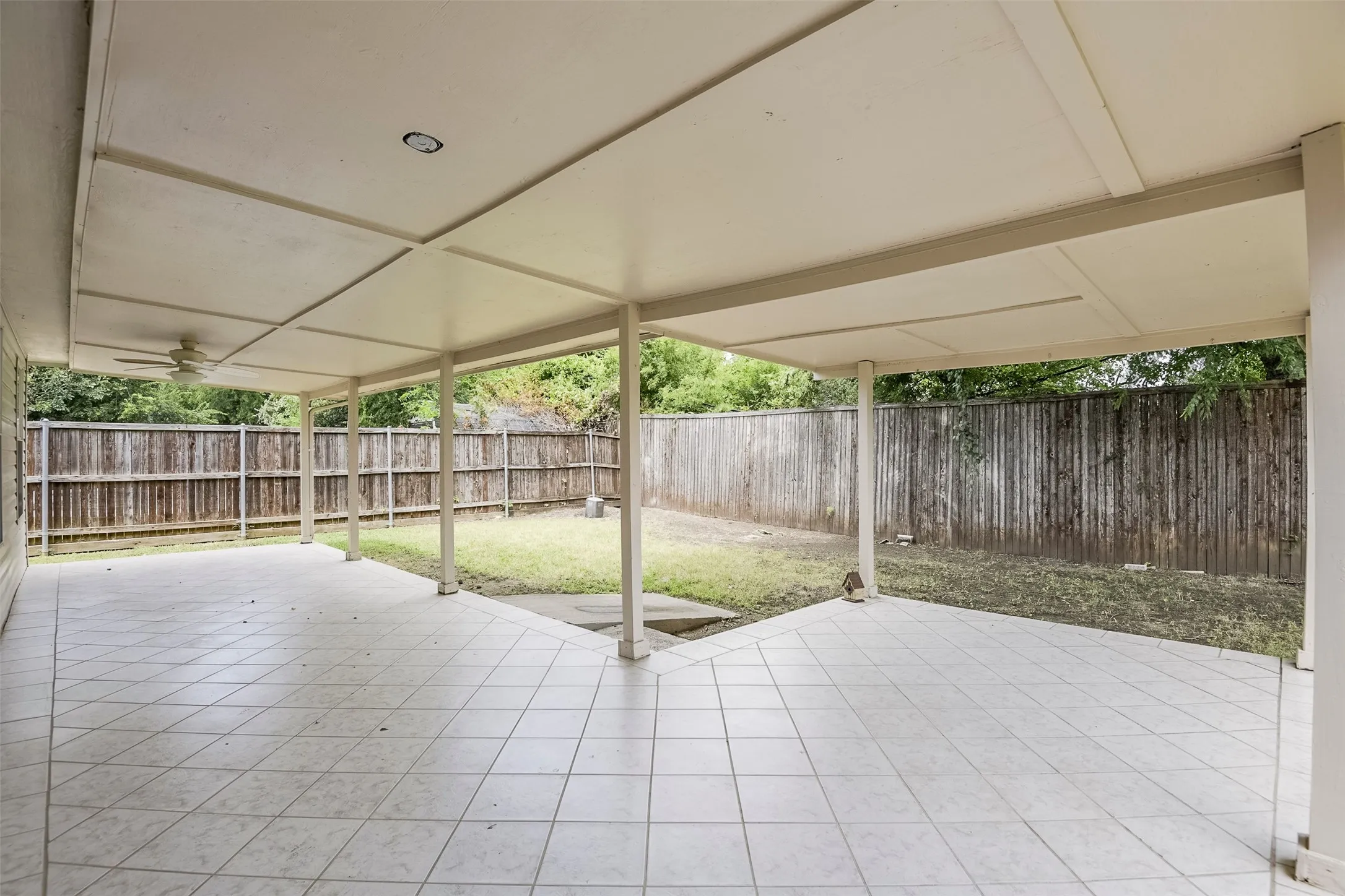 Spacious covered patio featuring ceiling fan, recessed lighting, and tile flooring