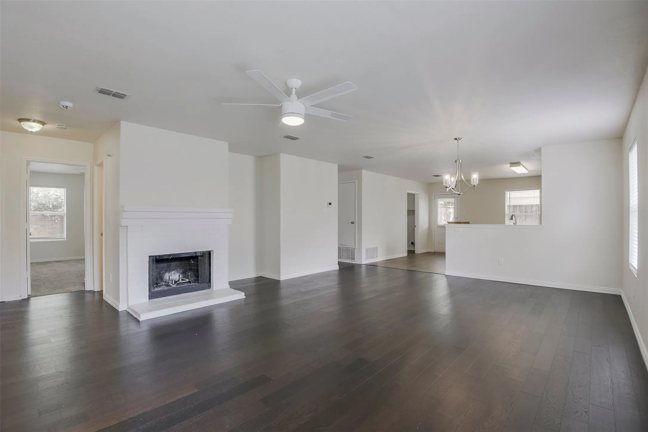 Expansive living area with dark wood-finish flooring