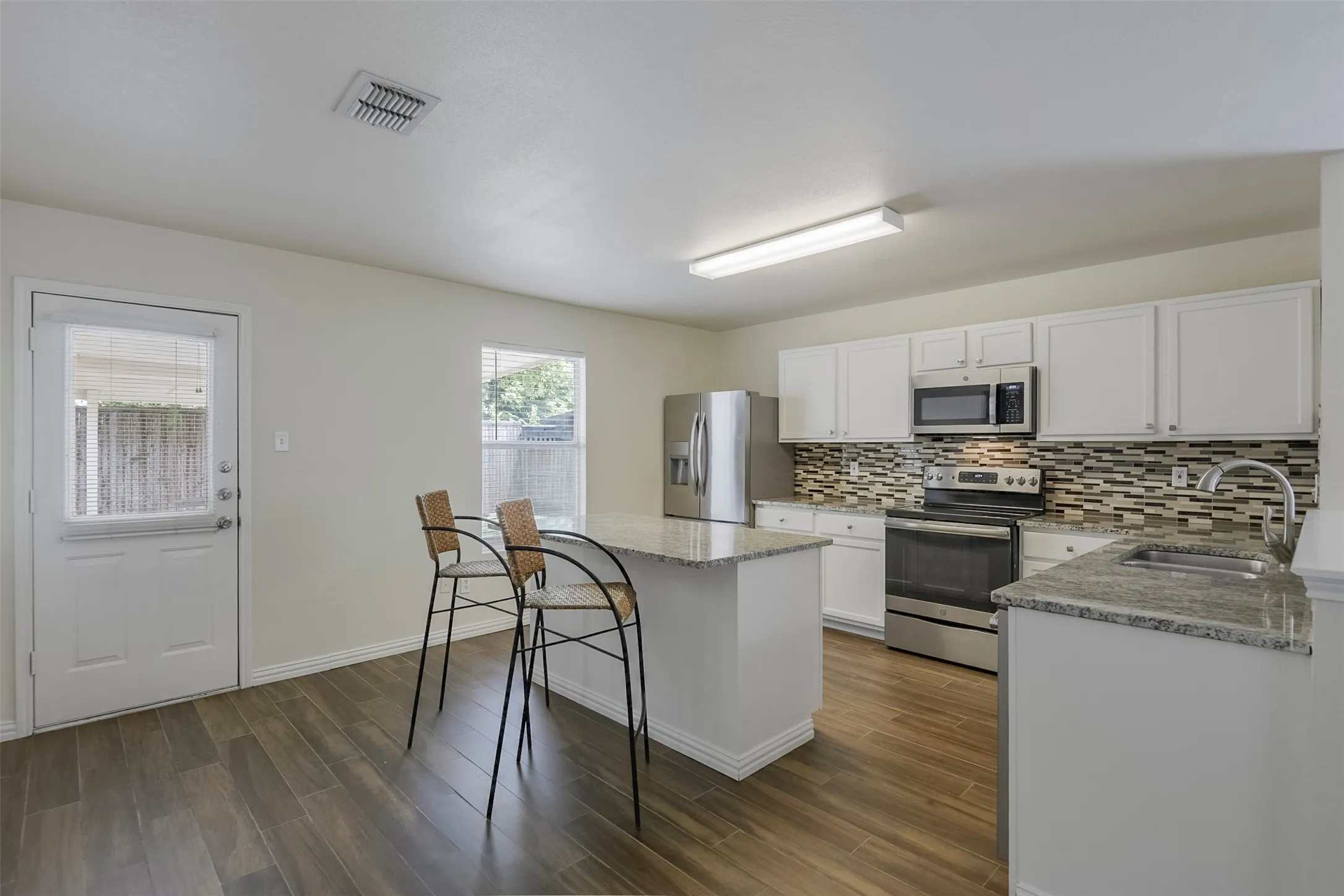 Kitchen featuring white cabinetry and stainless steel appliances