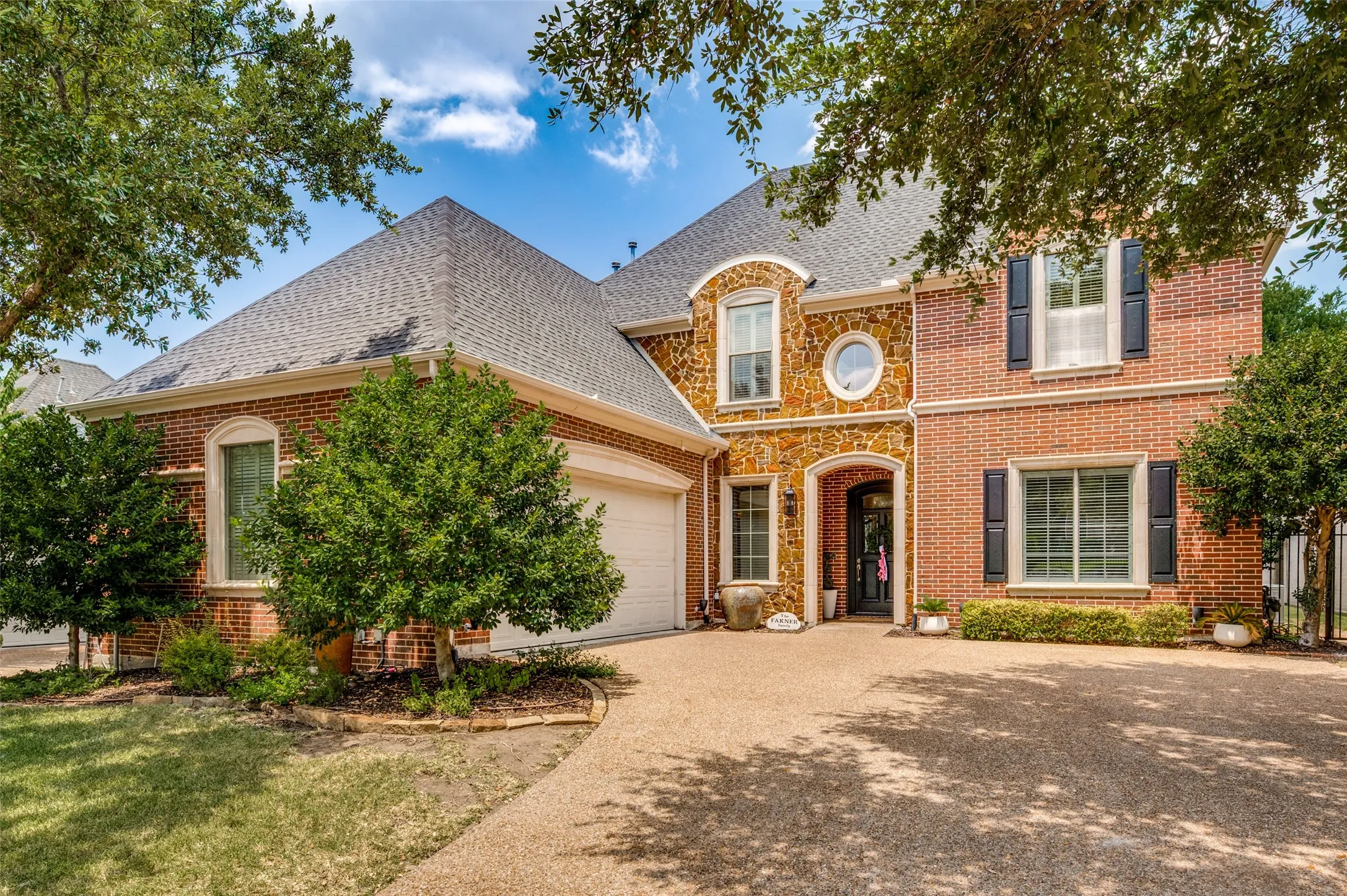 Brick and stone exterior with a multi-level roofline