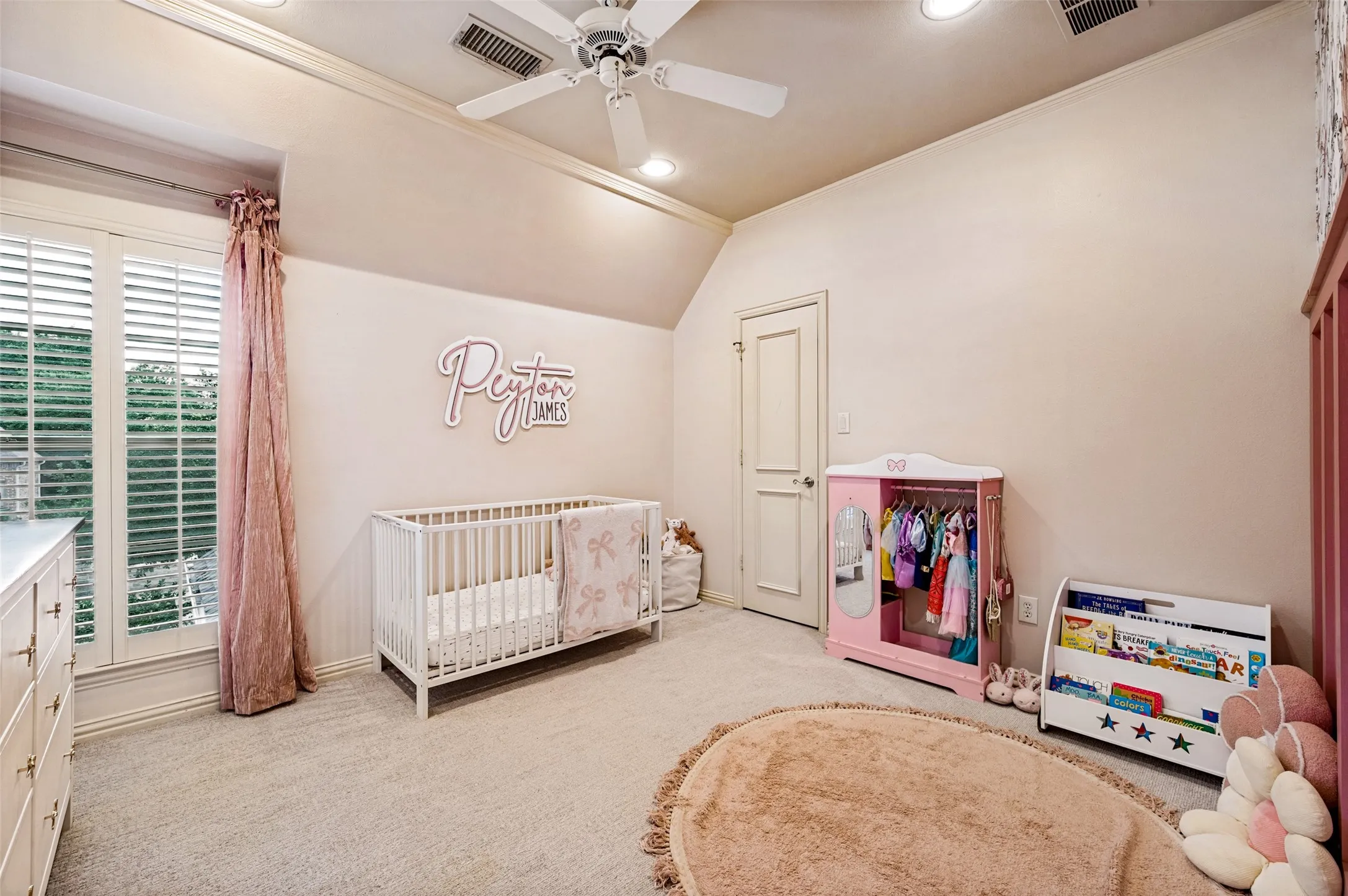 Carpeted room with a ceiling fan, recessed lighting, and a window with plantation shutters