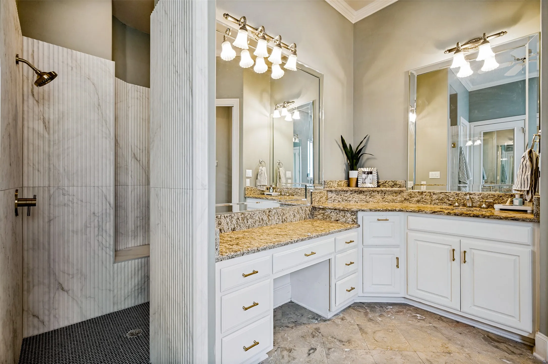 Walk-in shower with vertical fluted tile accents and a built-in bench