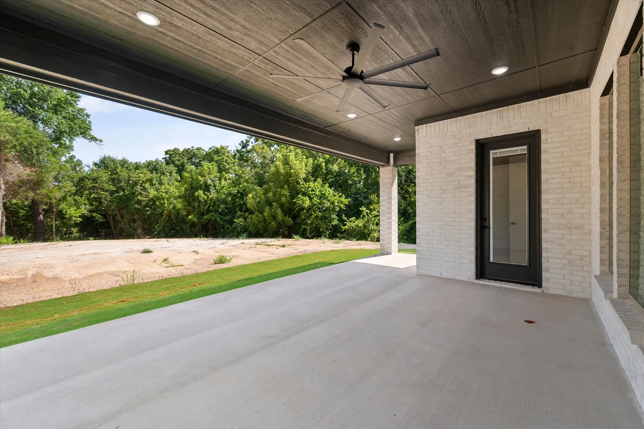 Spacious covered patio with concrete flooring, recessed lighting, and a ceiling fan