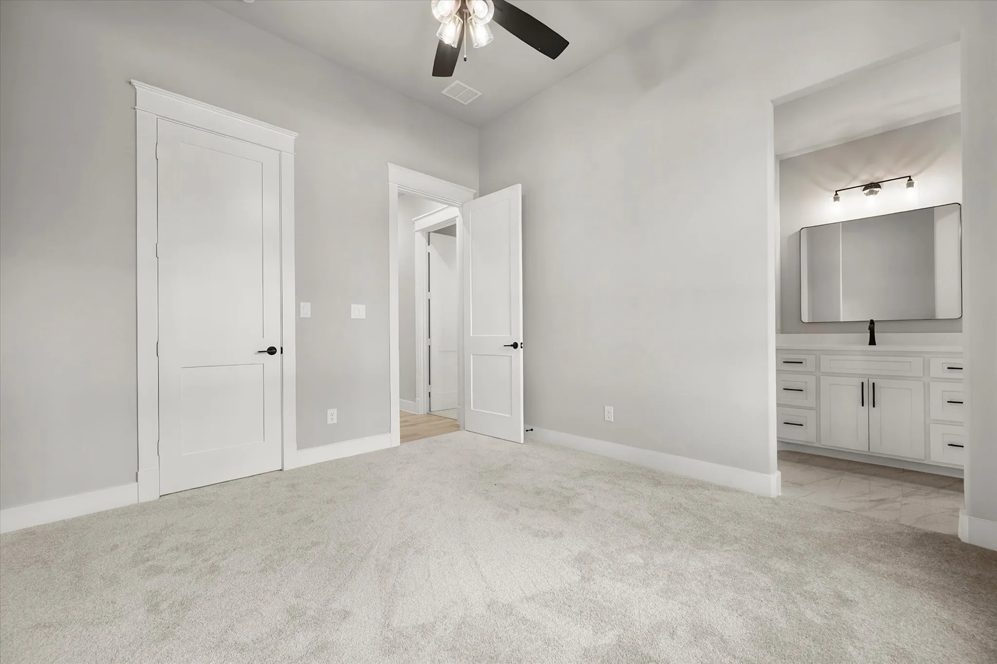 Plush carpeting, recessed lighting, and a ceiling fan with light