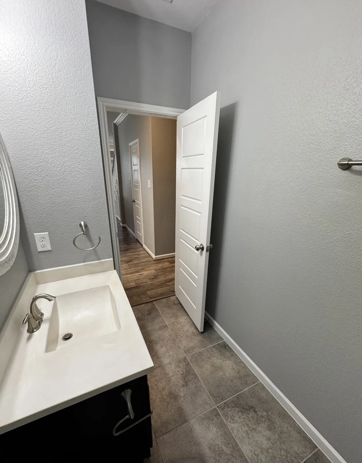 Vanity with integrated sink, brushed nickel faucet, and a black cabinet base
