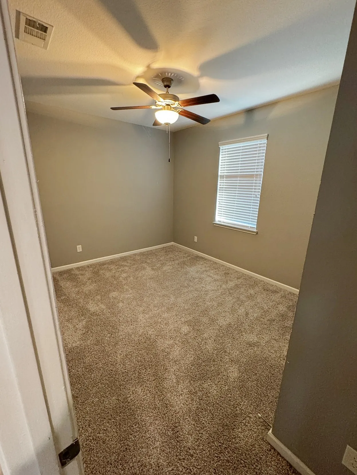 Wall-to-wall carpeting and neutral wall tones