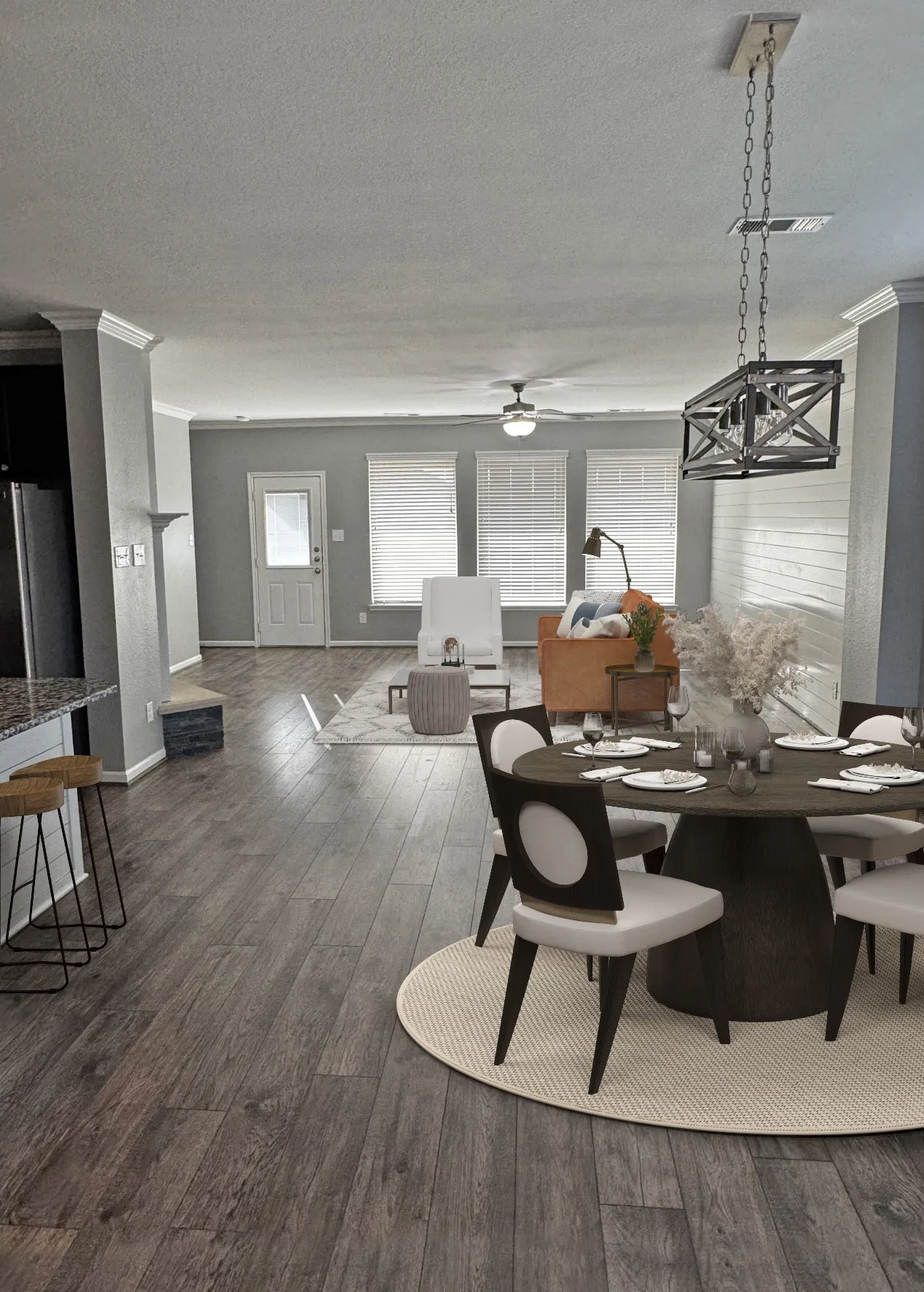 Wood-finish flooring throughout, a dining area with a linear chandelier, crown molding, and multiple windows with blinds